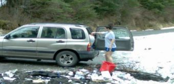 Still from video showing people illegally dumping trash.