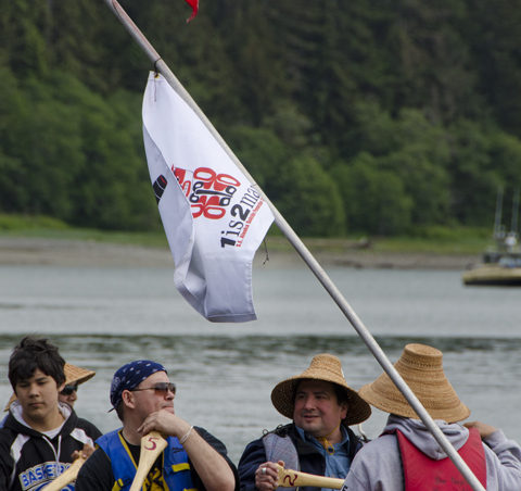 The lead canoe displays the flag for the 1 is 2 many program. The canoe trip was part of a suicide awareness campaign.