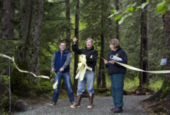 Brent Fischer, director of Juneau Parks and Recreation, Jack Kreinheder, Trail Mix President, and Marti Marshall, U.S. Forest Service District Ranger cut the ribbon to the Under Thunder trail in Mendenhall Valley.