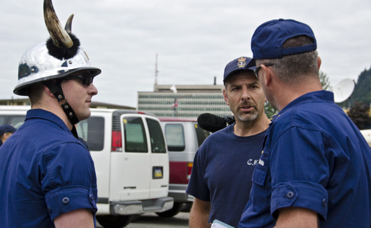 Ensign William Sharp from the SPAR and Scott Bell, lead hand for the Canadian Coast Guard Vessel Bartlett, listen to instructions for their teams during tug-of-war.