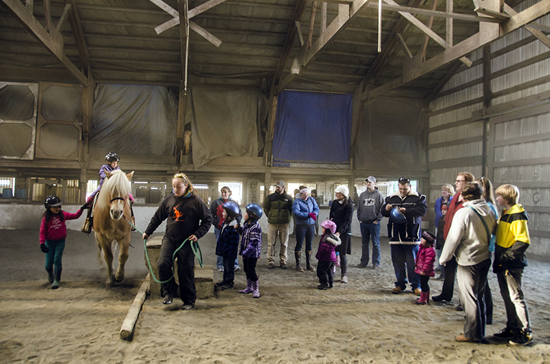 The first 4-H Pony Rides draws a crowd of eager children.