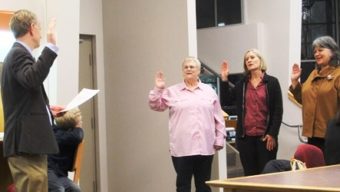 Superior Court Judge Phillip Pallenberg administers oath of office to newly elected Juneau School Board members Destiny Sargeant, Andi Story and Phyllis Carlson.