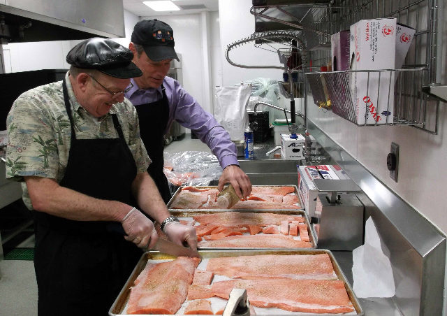 NANA staff prepare Alaska Coho Salmon from Taku Smokeries in the Thunder Mountain High School kitchen on Alaska Local Food Day 2012.