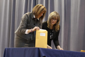 Division of Elections Director Gail Fenumiai prepares an envelope with Election Coordinator Lauri Wilson to be sealed by electors. (Photo by Annie Bartholomew/KTOO)