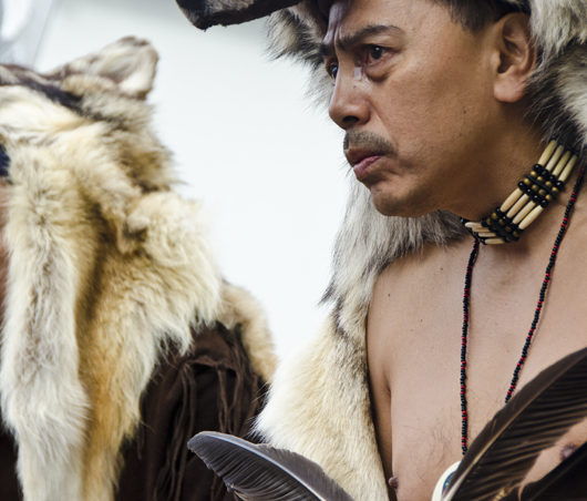 Southeast Alaska’s largest Native cultural gathering kicked off in earnest on June 7, with the Grand Entrance Procession in Juneau. A man with the Jilkaat Kwaan Heritage Dancers wears fur and carries a fan made of feathers.