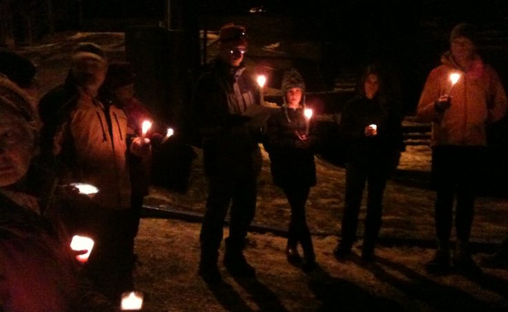 About two dozen people gathered near the Capital School and Terry Miller Legislative Office building on Dec. 16 for a candlelight vigil to remember the victims of the school shooting in Newtown, Connecticut.