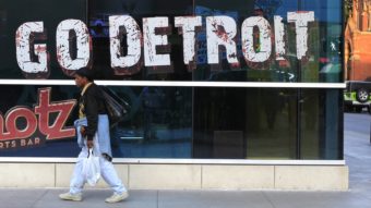 A pedestrian walks in downtown Detroit on Oct. 24, 2012. Carlos Osorio/AP
