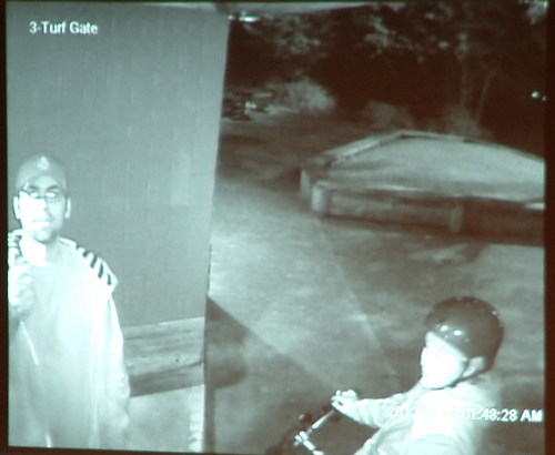Still of security camera footage that prosecutors say shows Ryan Martin (left) and Ashley Johnston (right on bicycle) at Adair-Kennedy Memorial Park before the arson on June 19th. Photo by Matt Miller/KTOO News
