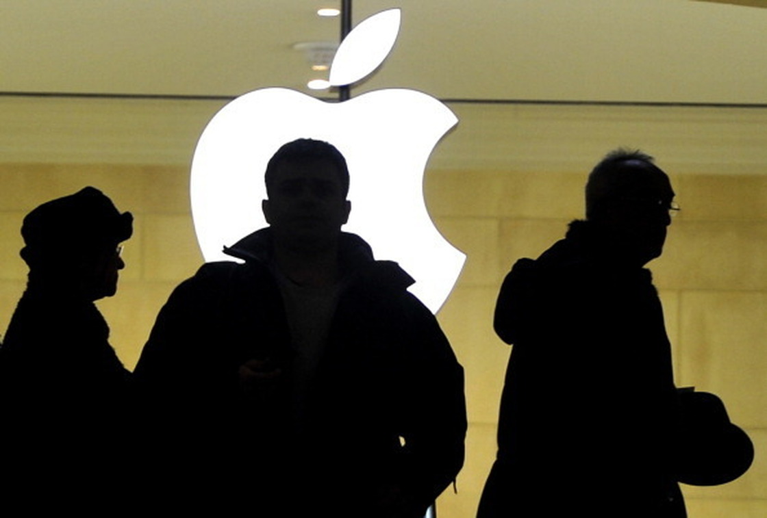 People walk past the Apple logo at the Apple Store at Grand Central Terminal in New York. Timothy A. Clary /AFP/Getty Images