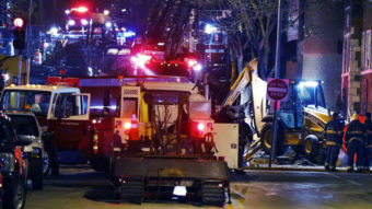 Fire fighters and utility workers at the scene of a massive gas explosion and fire Tuesday night in Kansas City, Mo. Orlin Wagner/AP