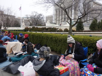 More than two dozen people bundled up to camp out before the U.S. Supreme Court for a seat to watch oral arguments in a same-sex marriage case on Tuesday. Elise Hu/NPR