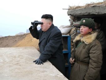 In this image released by North Korea's Central News Agency, leader Kim Jong Un is said to be using a pair of binoculars to look south during an inspection of a front-line army unit. Xinhua /Landov
