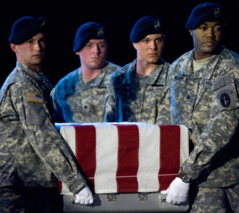 Members of the US Army's Old Guard carry team lift the remains of U.S. Army Specialist Israel Candelaria Mejias from San Lorenzo, Puerto Rico, as his body is returned on a C-17 to the U.S. from Iraq on April 7, 2009. Paul J. Richards /AFP/Getty Images