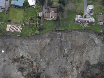Houses sit near the edge of a landslide on Whidbey Island on Wednesday. Ted S. Warren/Associated Press