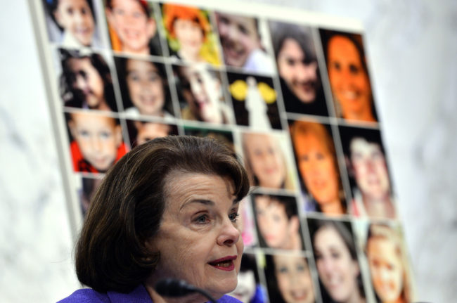  Pictures of Newtown's Sandy Hook Elementary School shooting victims are displayed as Senate Judiciary Committee chairperson Dianne Feinstein speaks during a hearing on "The Assault Weapons Ban of 2013" at the Hart Senate Office Building in Washington, DC, on February 27, 2013. Jewel Samad /AFP/Getty Images
