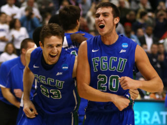 Florida Gulf Coast players Eddie Murray (No. 23) and Chase Fieler (No. 20) celebrate their win Sunday over San Diego State. The game was played at the Wells Fargo Center in Philadelphia. Elsa/Getty Images
