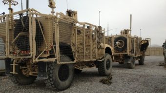 A pair of mine-resistant, ambush-protected vehicles are lined up for a convoy to Kandahar Airfield. One of the trucks broke down before leaving Forward Operating Base Frontenac. The unit has to move out 50 vehicles from the compound. Sean Carberry/NPR