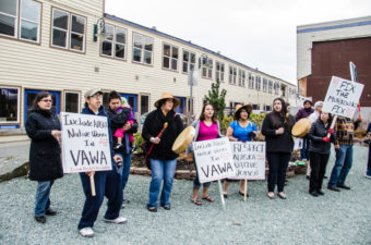 Ishmael Hope and a group of concerned people carried signs asking representatives to address issues with VAWA. (Photo by Heather Bryant/KTOO)