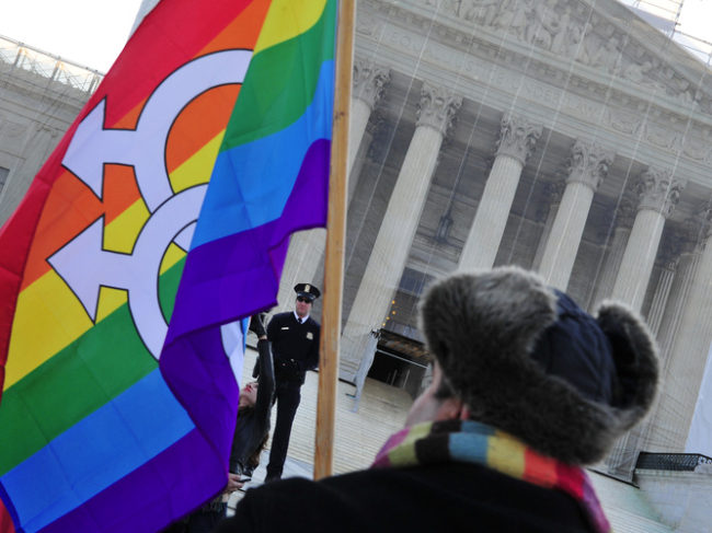 A pro-gay-marriage protester stands in front of the Supreme Court on Tuesday, the first of two days of oral arguments on challenges to laws that limit the definition of marriage to unions of a man and a woman. Karen Bleier/AFP/Getty Images 