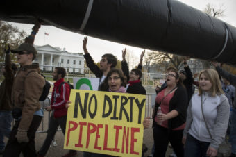 Demonstrators carry a mock pipeline as they pass the White House to protest the Keystone Pipeline, in Washington, D.C., on Nov. 18, 2012. Rod Lamkey Jr. /The Washington Times /Landov