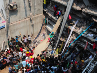 Volunteers on Thursday use a length of textile as a slide to move victims from the rubble of a collapsed building in Savar, Bangladesh. AFP/Getty Images