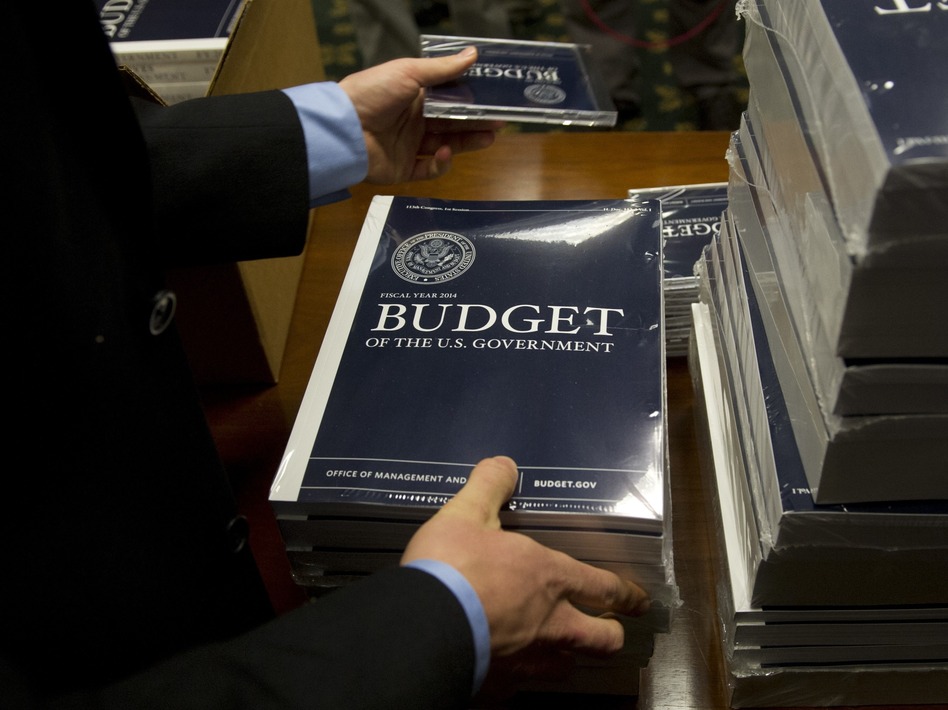 Senate budget committee staffers unpack boxes of President Obama's 2014 budget proposal on Wednesday. Saul Loeb/AFP/Getty Images