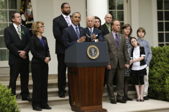 President Obama makes a statement on gun violence as Vice President Joe Biden, former U.S. Rep. Gabrielle Giffords and family members of Newtown, Conn., shooting victims look on at the White House Rose Garden. Win McNamee/Getty Images