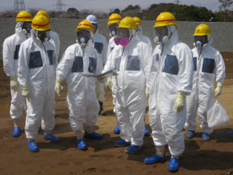 As they inspected an underground storage pool near the crippled Fukushima Daiichi nuclear power plant earlier this month, Tokyo Electric Power Co. President Naomi Hirose (4th from left) and other officials wore protective suits and masks. Radioactive water stored in some of the pits has leaked. Tokyo Electric Power Co./Reuters /Landov
