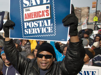 A Chicago postal worker protests in support of Saturday mail delivery in February. John Gress/Getty Images