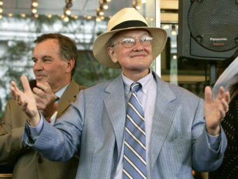 Film critic Roger Ebert acknowleges the applause of those gathered to pay tribute to him at the historic Chicago Theatre on July 18, 2005. Charles Rex Arbogast/AP