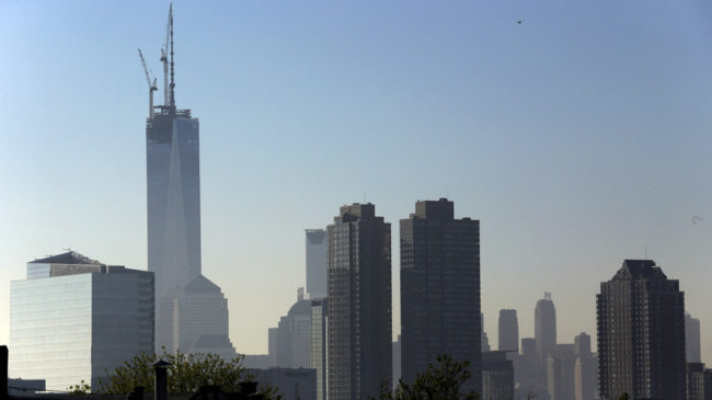 One World Trade Center stands at its full height of 1,776 feet Friday, after a crane lifted its spire into place. The New York City skyline is seen here from the Heights neighborhood of Jersey City, N.J. Julio Cortez/AP
