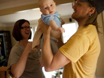 Dawn Heisey-Grove of Alexandria, Va., hands off son Zane to father Jonathan Heisey-Grove after a midday feeding. The couple were both working full time when Jonathan lost his job as a graphic designer two years ago. She's a public health analyst. He's now a stay-at-home dad. Kainaz Amaria/NPR