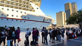 Passengers queue at Sydney's Circular Quay to board the Carnival Spirit for a Pacific cruise, on Thursday. William West/AFP/Getty Images