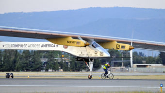 The Solar Impulse takes off from Moffett Field NASA Ames Research Center in Mountain View, Calif., Friday, as a team member rides an electric bike alongside the plane. AFP/AFP/Getty Images