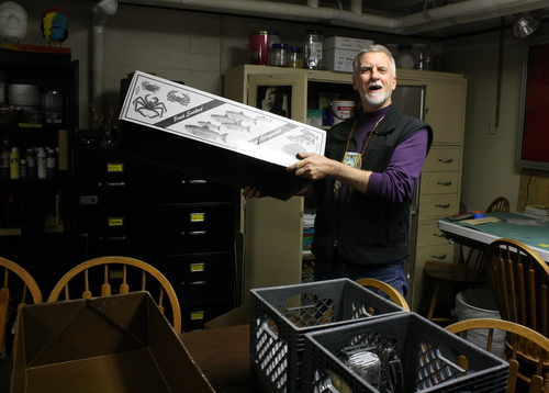 Charlie Bean uses fish boxes to pack up his workspace at the Bill Brady Healing Center. He jokes that people in other states probably don’t use fish boxes like this. (KCAW photo by Ed Ronco)