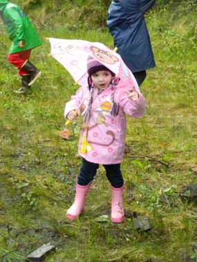 A young rainboot racer tests her pink raingear before Saturday’s race
