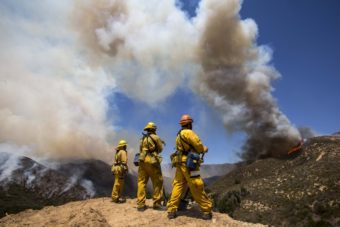 Firefighters keep watch at Green Valley as the fire has burned more than 1,400 acres since Thursday in the Angeles National Forest just north of Castaic, in California. Zhao Hanrong /Xinhua /Landov