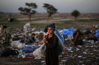 Afghan refugee children collect items of use from a pile of garbage on the outskirts of Islamabad, Pakistan. Muhammed Muheisen/AP