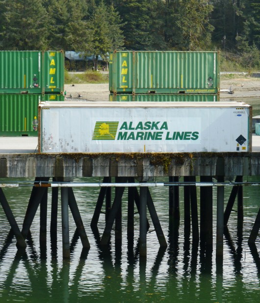 Alaska Marine Lines containers wait for loading on Yakutat’s dock. AML is part of Lynden. Image by Ed Schoenfeld, CoastAlaska News.