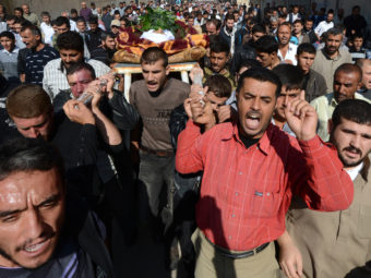 Mourners carry the body of a man killed last fall in the northern Syrian town of Azaz. Philippe Desmazes /AFP/Getty Images