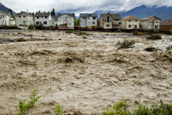 Houses damaged along the edge of Cougar Creek in Canmore, Canada. Widespread flooding caused by torrential rains washed out bridges and roads prompting the evacuation of thousands on Thursday. John Gibson/Getty Images