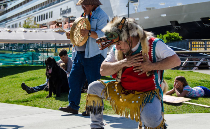John Smith the 3rd kneels during a dance. (Photo by Heather Bryant/KTOO)