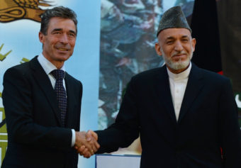 Afghan President Hamid Karzai shakes hands with NATO Secretary-General Anders Fogh Rasmussen after a security handover ceremony at a military academy outside Kabul on Tuesday. Shah Marai/AFP/Getty Images