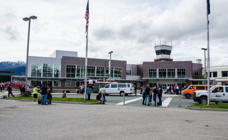 A crowd gathers outside the airport.