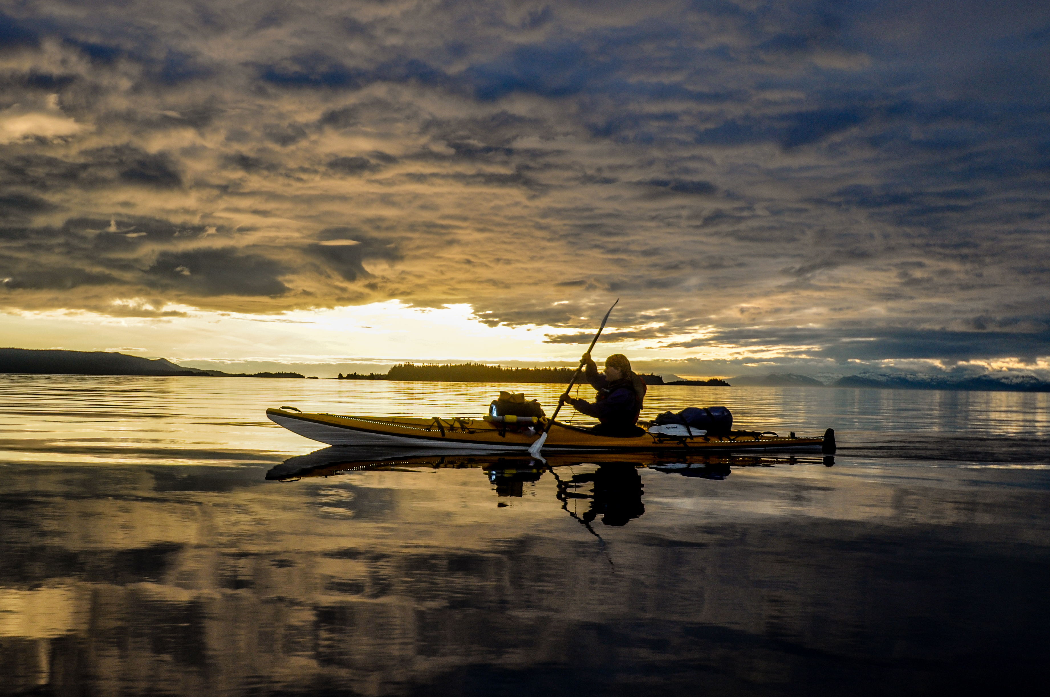 The "A Trip South" team kayaks down the Inside Passage during sunset. Photo courtesy of Lia Heifitz. 