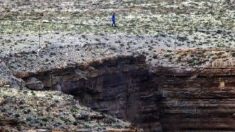 Daredevil Nik Wallenda crosses a tightrope 1,500 feet above the Little Colorado River Gorge, Ariz., on Sunday. Rick Bowmer/AP