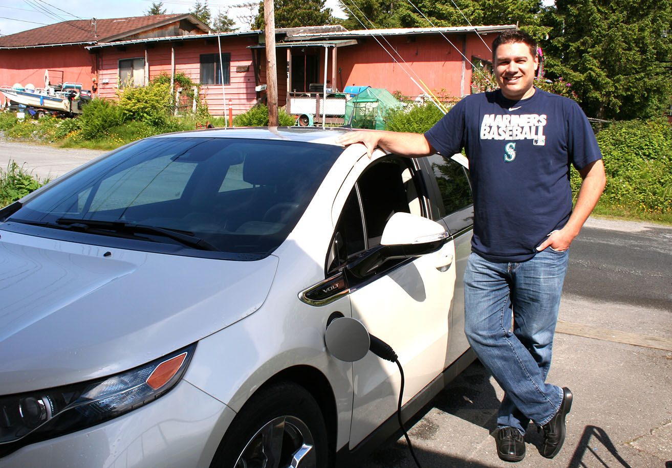 Sitka’s lone electric car owner, Michael Mahoney, standing next to his Chevy Volt. 