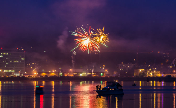 Boats anchored in Juneau's harbor watch the fireworks.