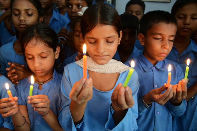Indian school children hold candles as they pay tribute to school children who died from food poisoning in Saran district of Bihar state. Narinder Nanu /AFP/Getty Images