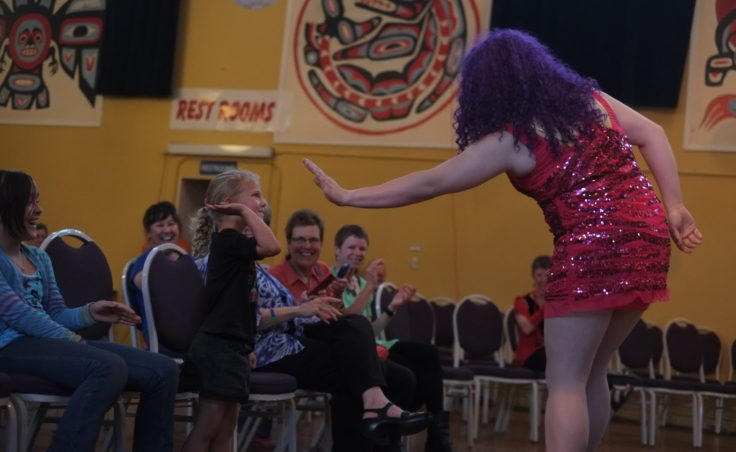 drag queen gives girl a high five